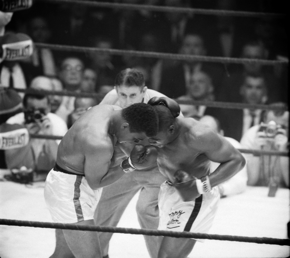 Cassius Clay and Sonny Liston grapple during their first heavyweight title fight, Feb. 1964.