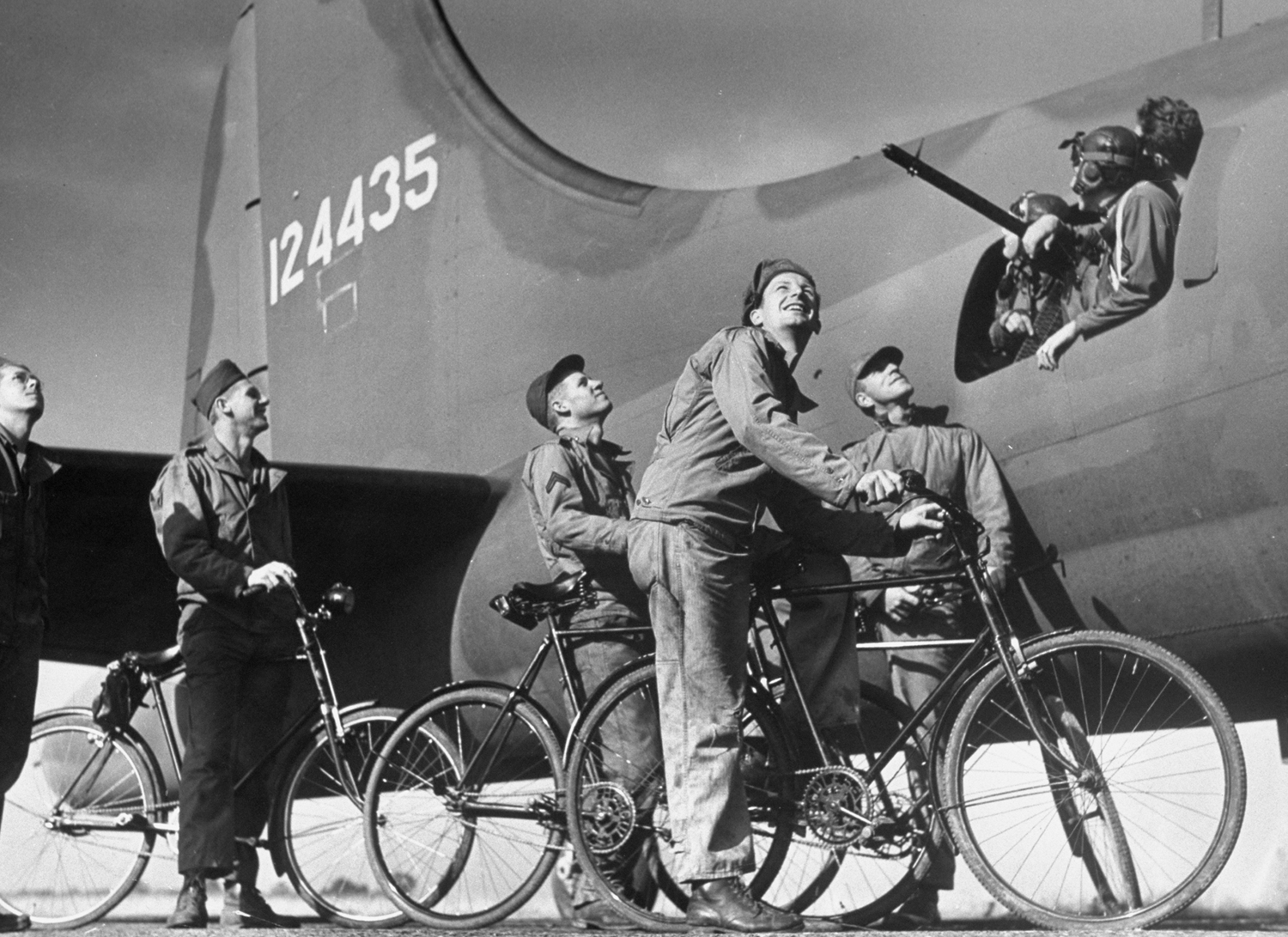 A B-17 Flying Fortress' ground crew bids goodbye to Fortress gunners before bomber takes off on a raid in Europe, 1942.