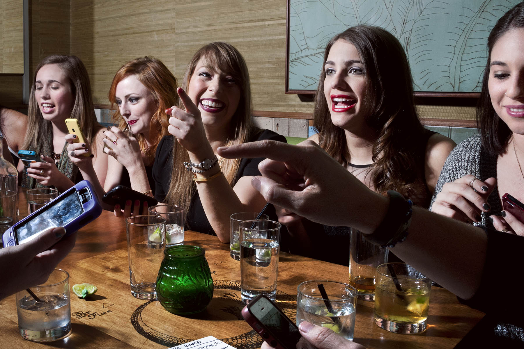 Girlfriends gather at a bar to play a Tinder drinking game