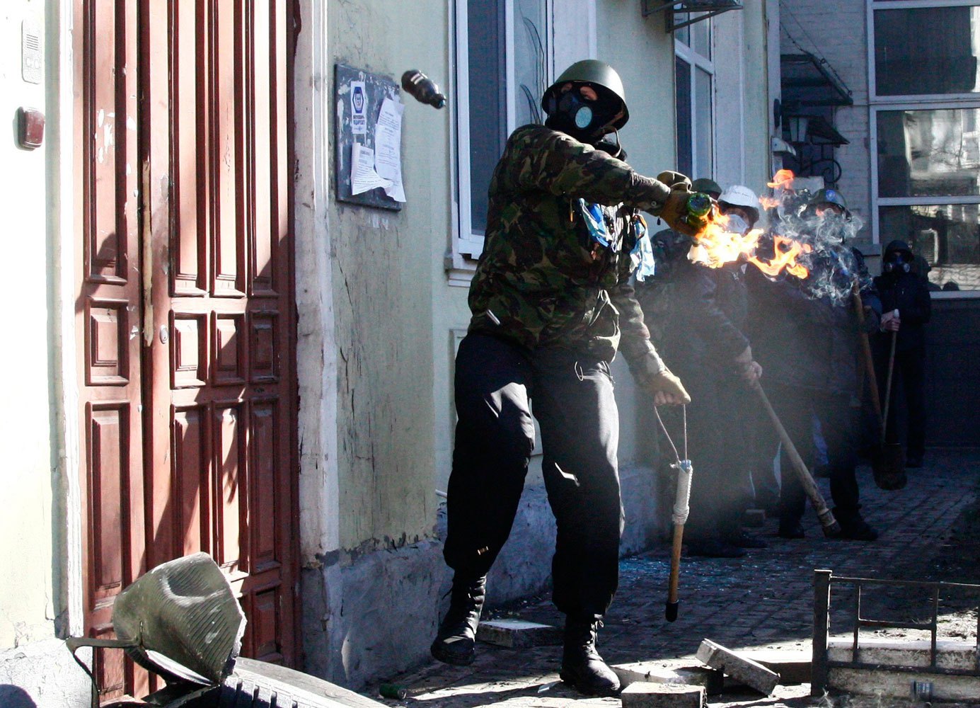 An anti-government protester holds a Molotov cocktail during clashes with Interior Ministry members in Kiev, on Feb. 18, 2014.