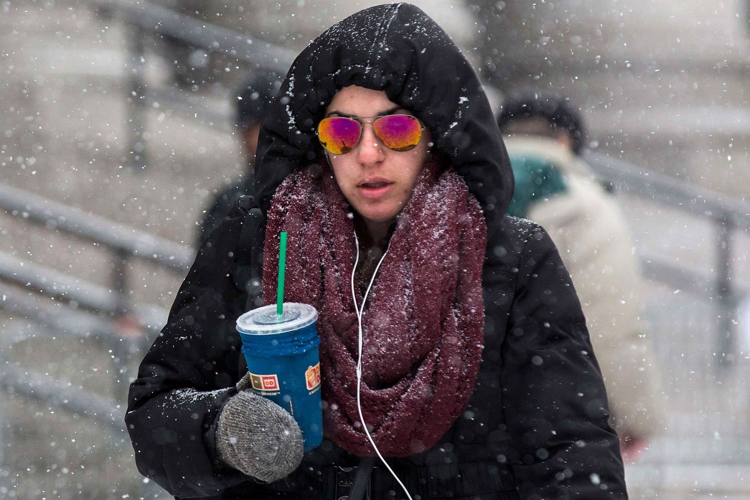 A woman walks through the blowing snow in the downtown area of New York