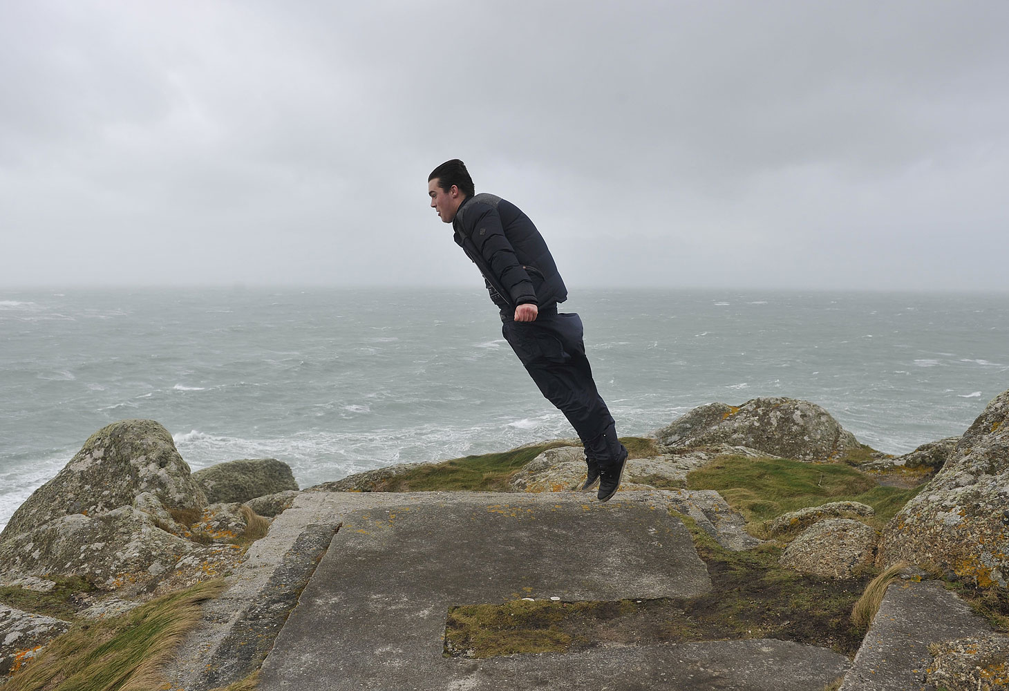 A man floats in the air as he uses his jacket to catch gale force winds as a storm hits the seafront at Sennen Cove at the Western tip of Cornwall, UK, Feb. 8, 2014. (Mark Hemsworth—London News Pictures/Zumapress)