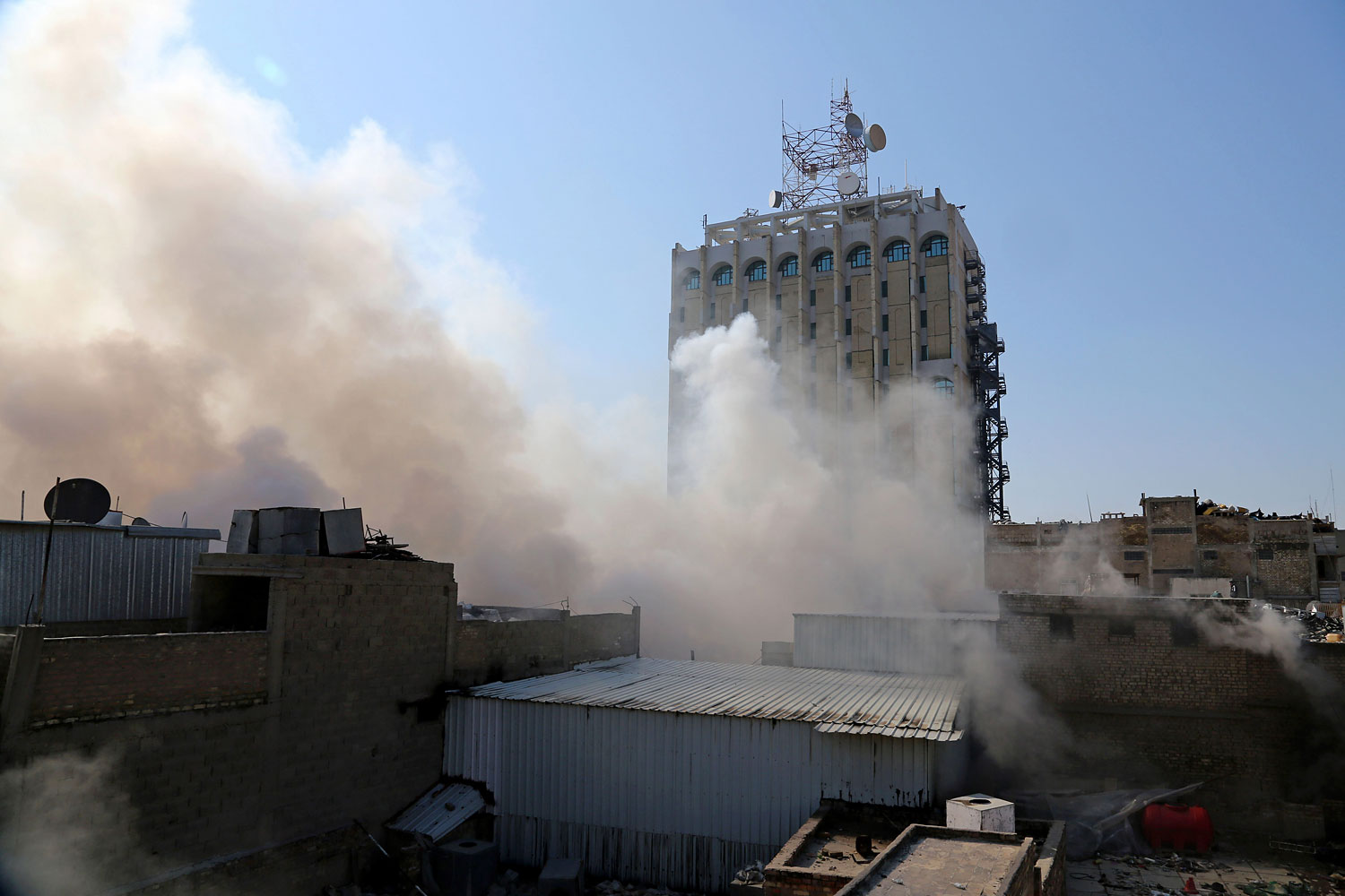 Smoke rises after a parked car bomb went off at a commercial center in Khilani Square in central Baghdad, Feb. 5, 2014. (Karim Kadim / AP)