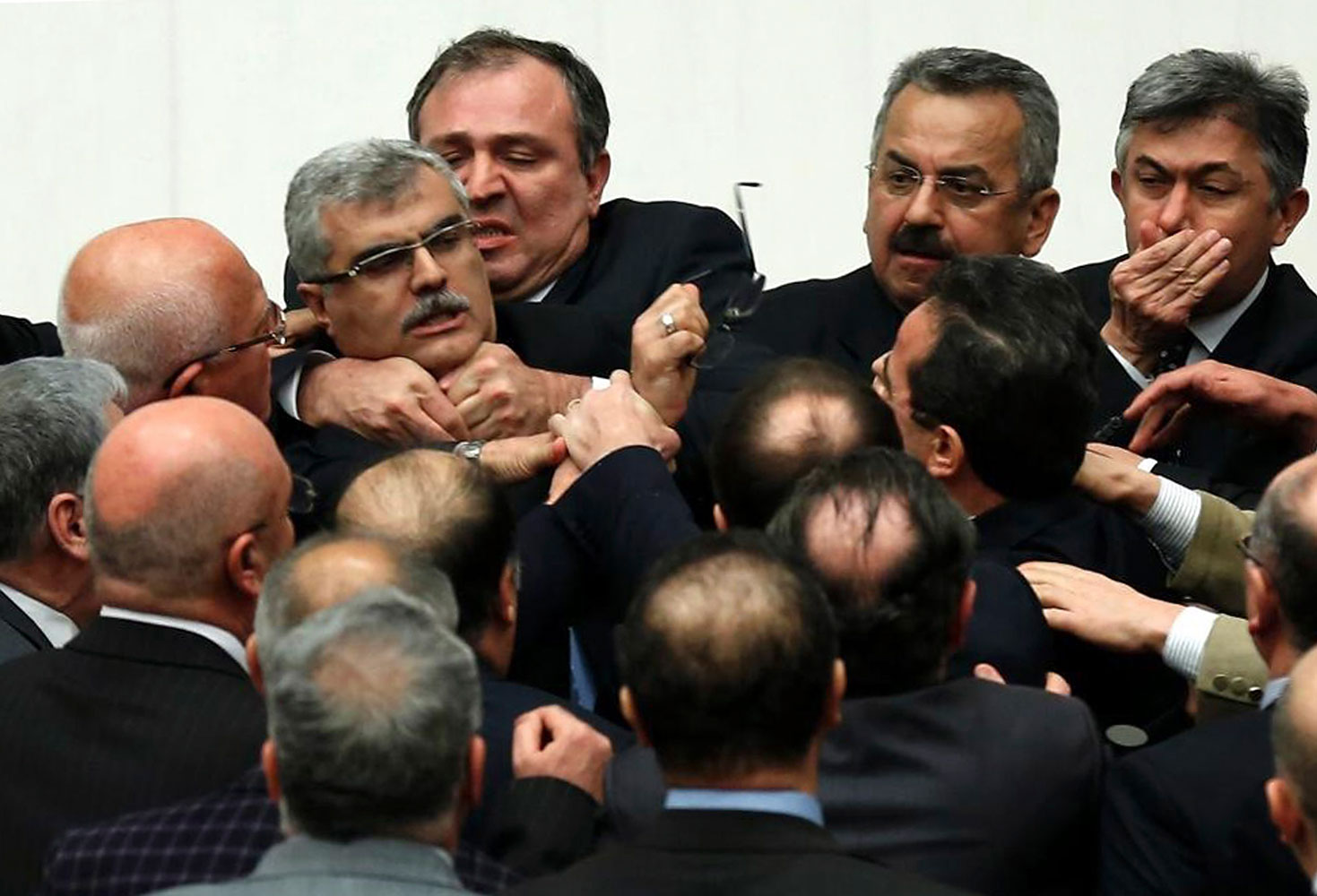 Turkish legislators from Prime Minister Recep Tayyip Erdogan's ruling party and the main opposition Republican People's Party brawl during a tense all-night debate over a controversial law on changes to a council that appoints and overseas judges and prosecutors, in Ankara, early Saturday, Feb. 15, 2014.