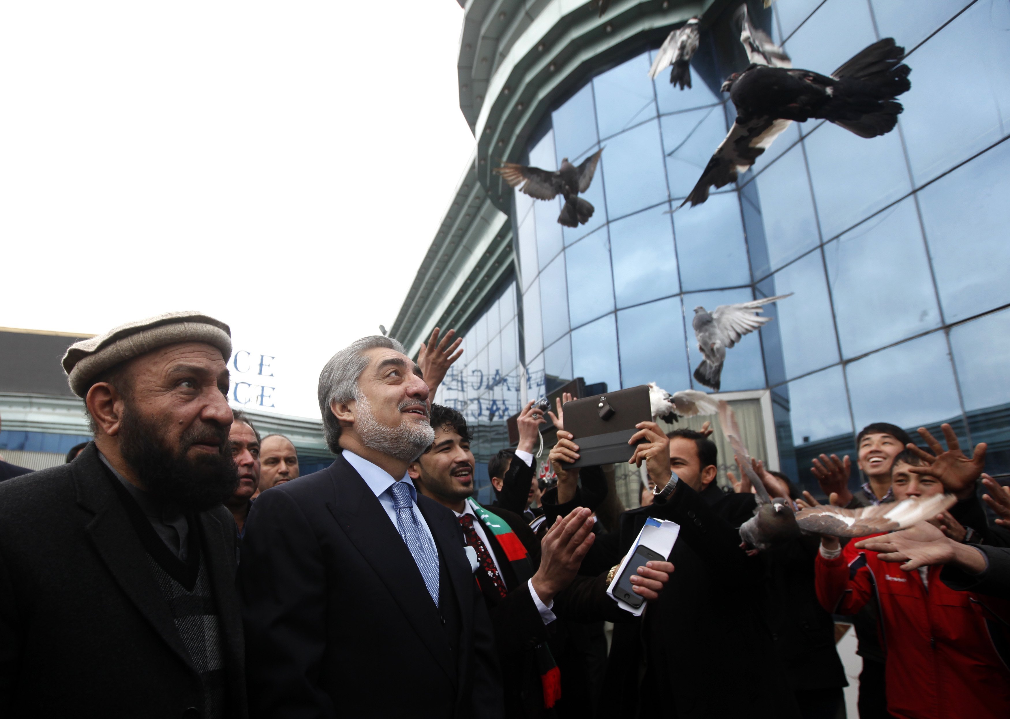 Supporters of Afghan presidential candidate Abdullah Abdullah release pigeons during the first day of the presidential election campaign in Kabul