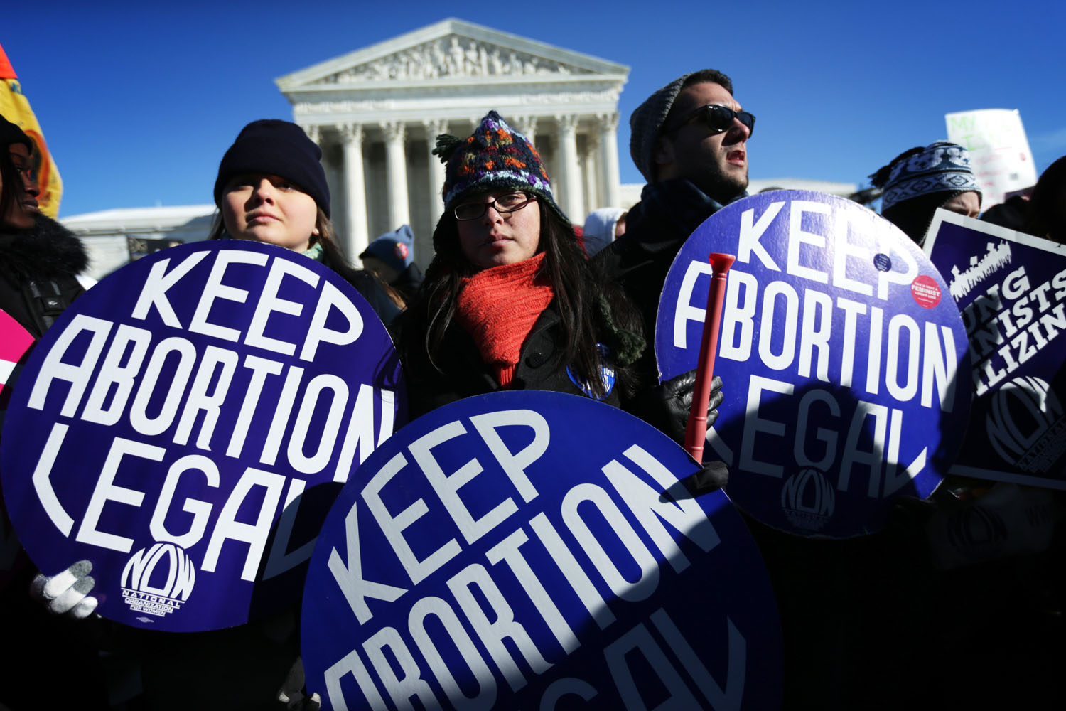 Pro-choice activists hold signs as marchers of the annual March for Life arrive in front of the U.S. Supreme Court Jan. 22, 2014 on Capitol Hill in Washington, D.C. (Alex Wong&mdash;Getty Images)