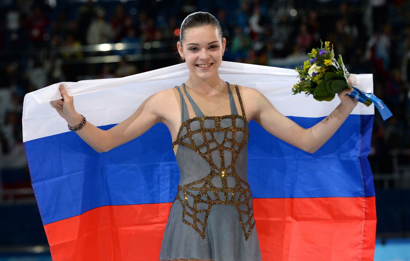 Russia's gold medalist Adelina Sotnikova celebrates during the Women's Figure Skating Flower Ceremony at the Iceberg Skating Palace during the Sochi Winter Olympics on February 20, 2014.