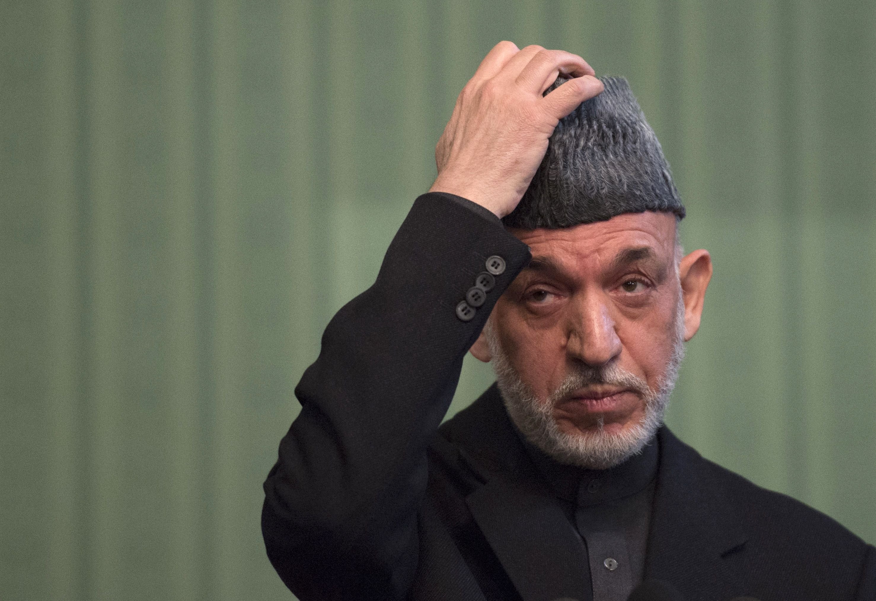 Afghan President Hamid Karzai gestures during a press conference at the Presidential Palace in Kabul on January 25, 2014. (Johannes Eisele—AFP/Getty Images)