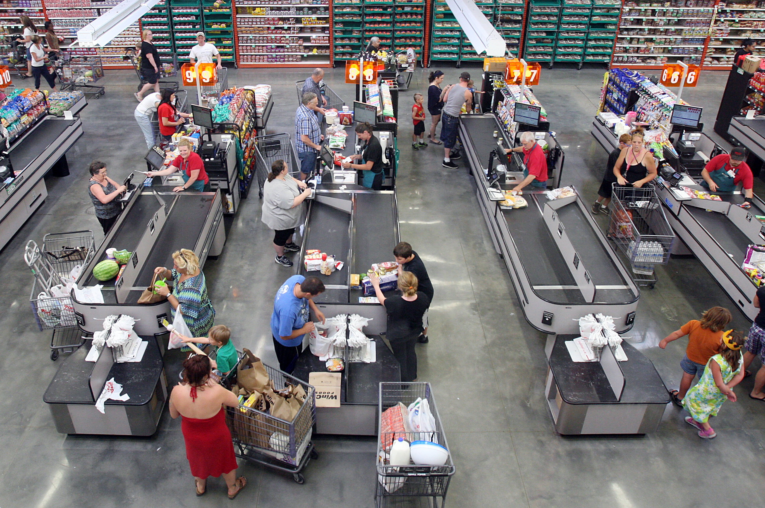 Customers bag their own groceries at checkout counters at WinCo Foods on Fairview Avenue in Boise, Idaho, on July 1, 2013 (Joe Jaszewski / The Idaho Statesman / AP)