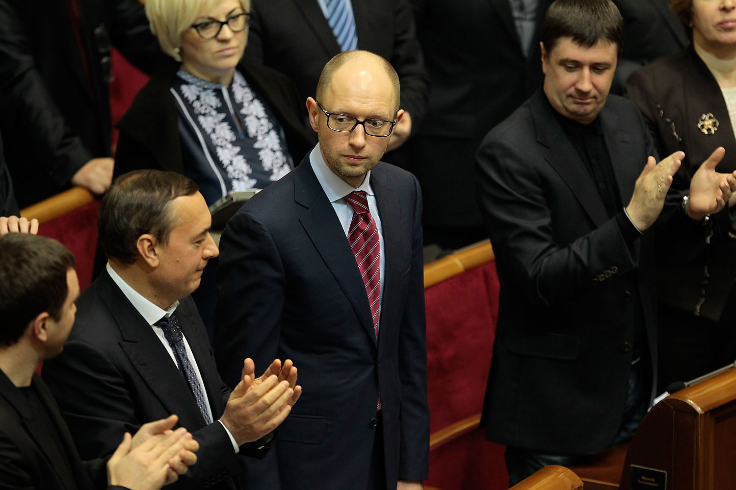 Ukrainian lawmakers applaud new Prime Minister Arseniy Yatsenyuk, center, during a session at the Ukrainian parliament in Kiev, Feb. 27, 2014. (Sergei Chuzavkov&mdash;AP)