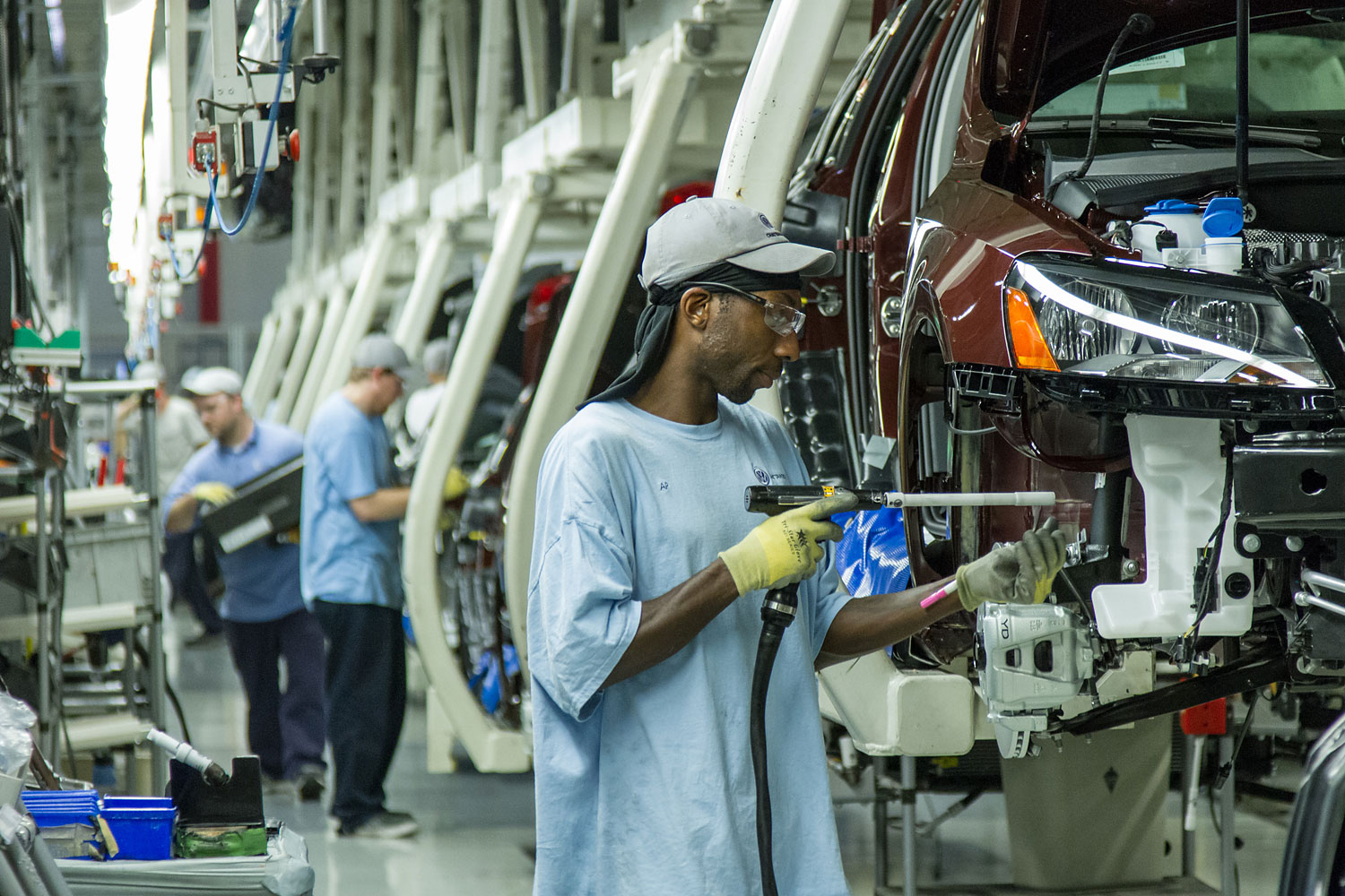 In this June 12, 2013, photo, workers assemble Volkswagen Passat sedans at the German automaker's plant in Chattanooga, Tenn.