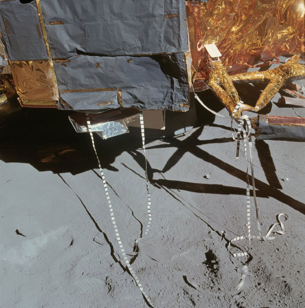 The scientific equipment bay (SEQ Bay) was a storage area in the base of the lunar module where instruments were kept en route to the moon. Irwin photographed the open hatch of the bay, with its deployment tapes—the lanyards used to extract the instruments—dangling everywhere.