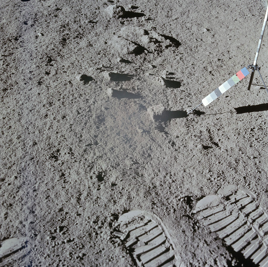 Lunar astronauts often took two pictures of the same sample spot to allow a stereoscopic perspective when the pictures were later developed. This is the second of a pair Scott took after he scooped up soil at one site. The multi-colored strip on he right was used as a color reference.