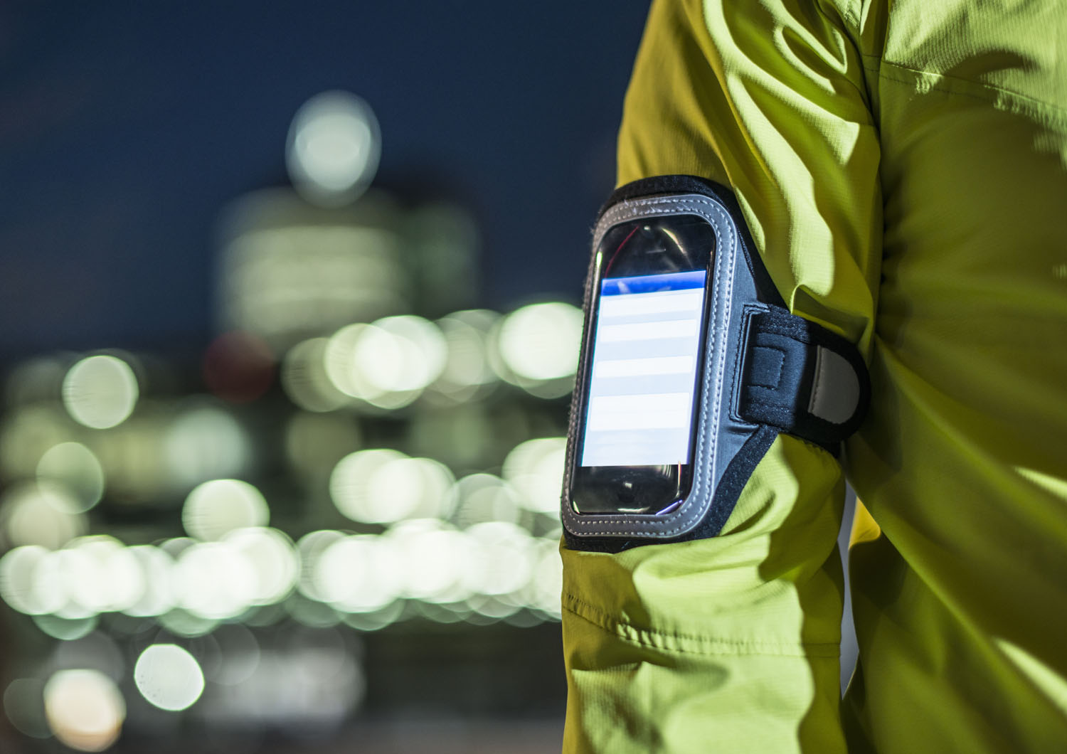 A runner wears a smartphone on his arm. 