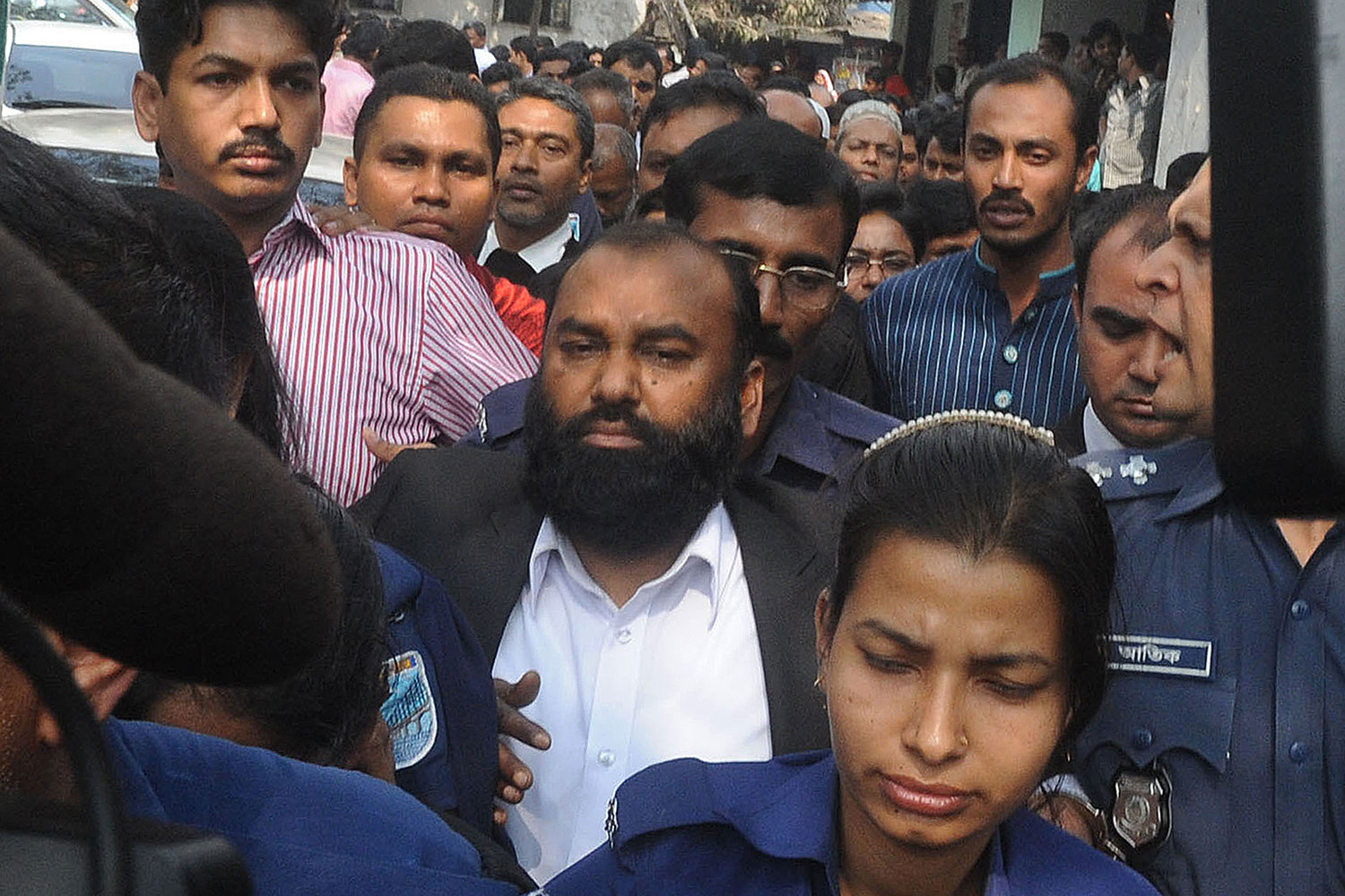 The owner of Tazreen Fashions, Delwar Hossain (C) is escorted to court in Dhaka on Feb. 9, 2014. (STR / AFP / Getty Images)