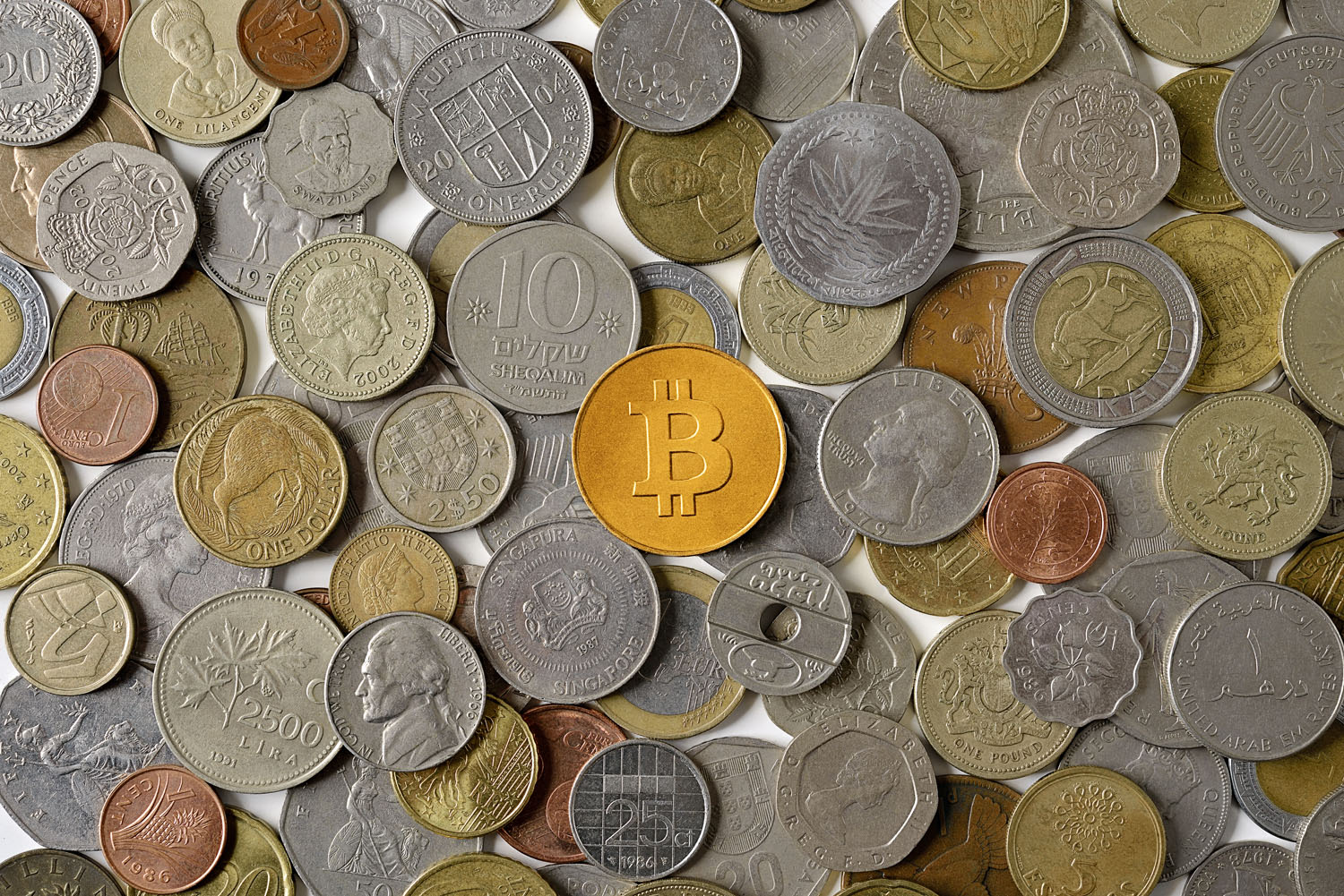 Bitcoin, center, is surrounded by various world coins. (David Malan&mdash;Getty Images)
