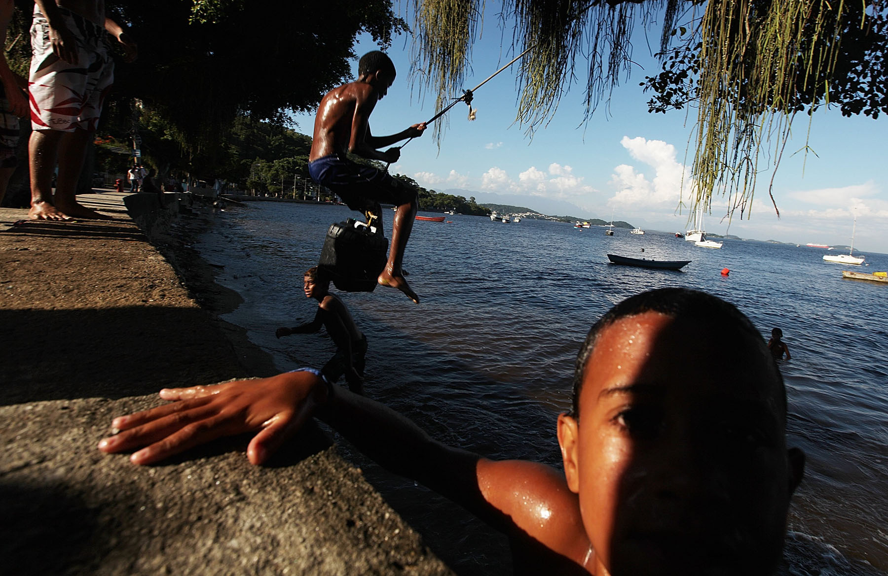 Kids play along the shoreline of Guanabara Bay in the Ilha do Governador neighborhood of Rio de Janeiro on Jan. 21, 2014.