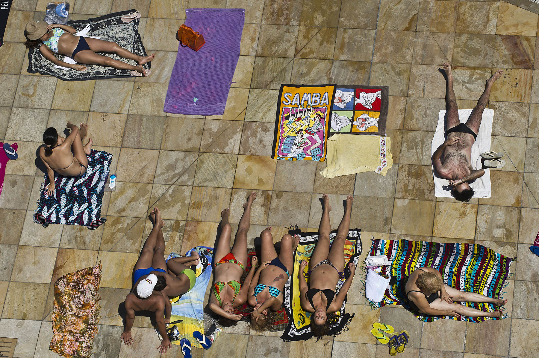 People lounge poolside at the SESC Belenzinho club in Sao Paulo, Brazil on Jan. 31, 2014.