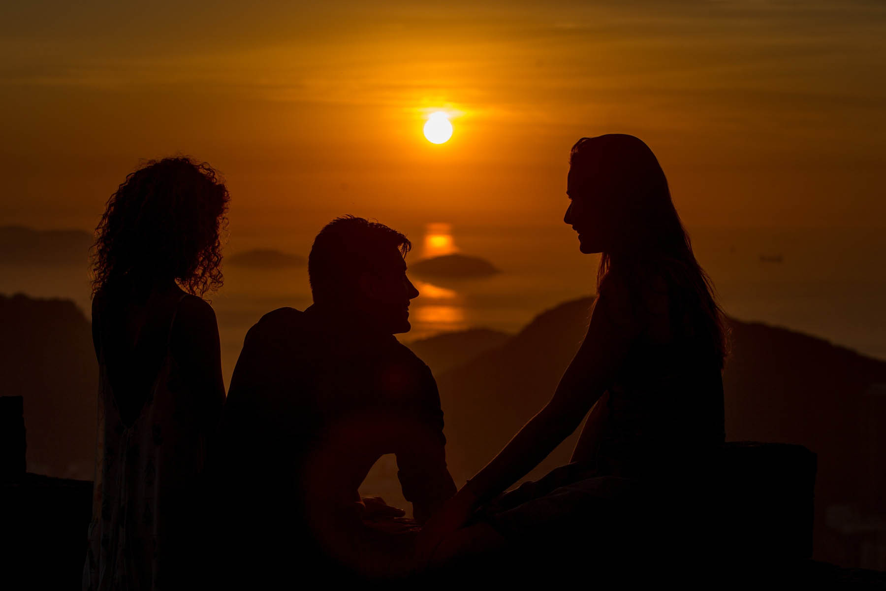 Tourists are silhouetted as they watch the sunrise near the Guanabara Bay in Rio de Janeiro,  Jan. 16, 2014.