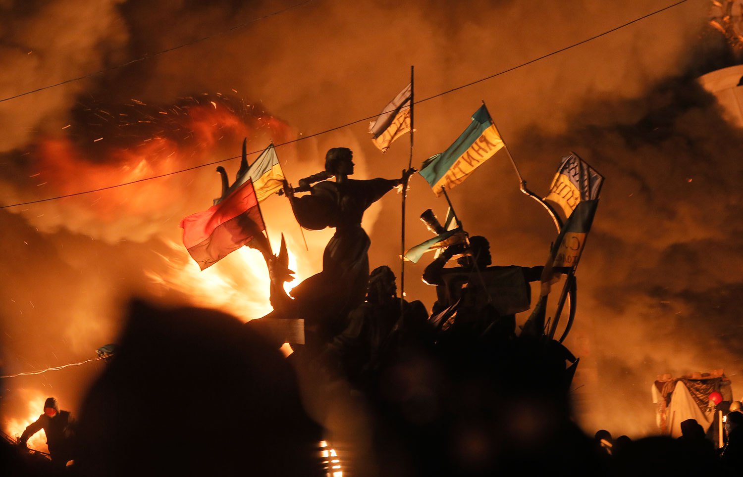 Monuments to Kiev's founders burn as anti-government protesters clash with riot police in Kiev's Independence Square, Feb. 18, 2014.