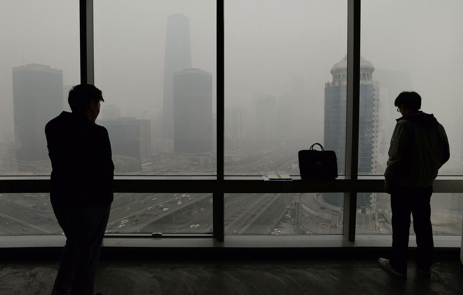 People look at an area of central Beijing blanketed in smog on Feb. 24, 2014.