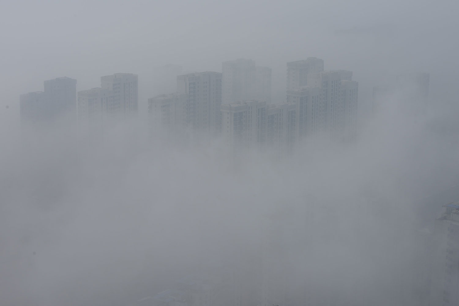 Buildings are shrouded in heavy smog on Feb. 25, 2014, in Qingdao, Shandong Province.