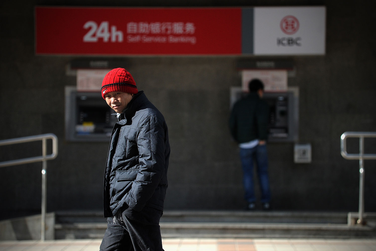 A man walking past a ATM machine at the entrance of a bank in Beijing, Jan. 25, 2014 (Wang Zhao / AFP / Getty Images)