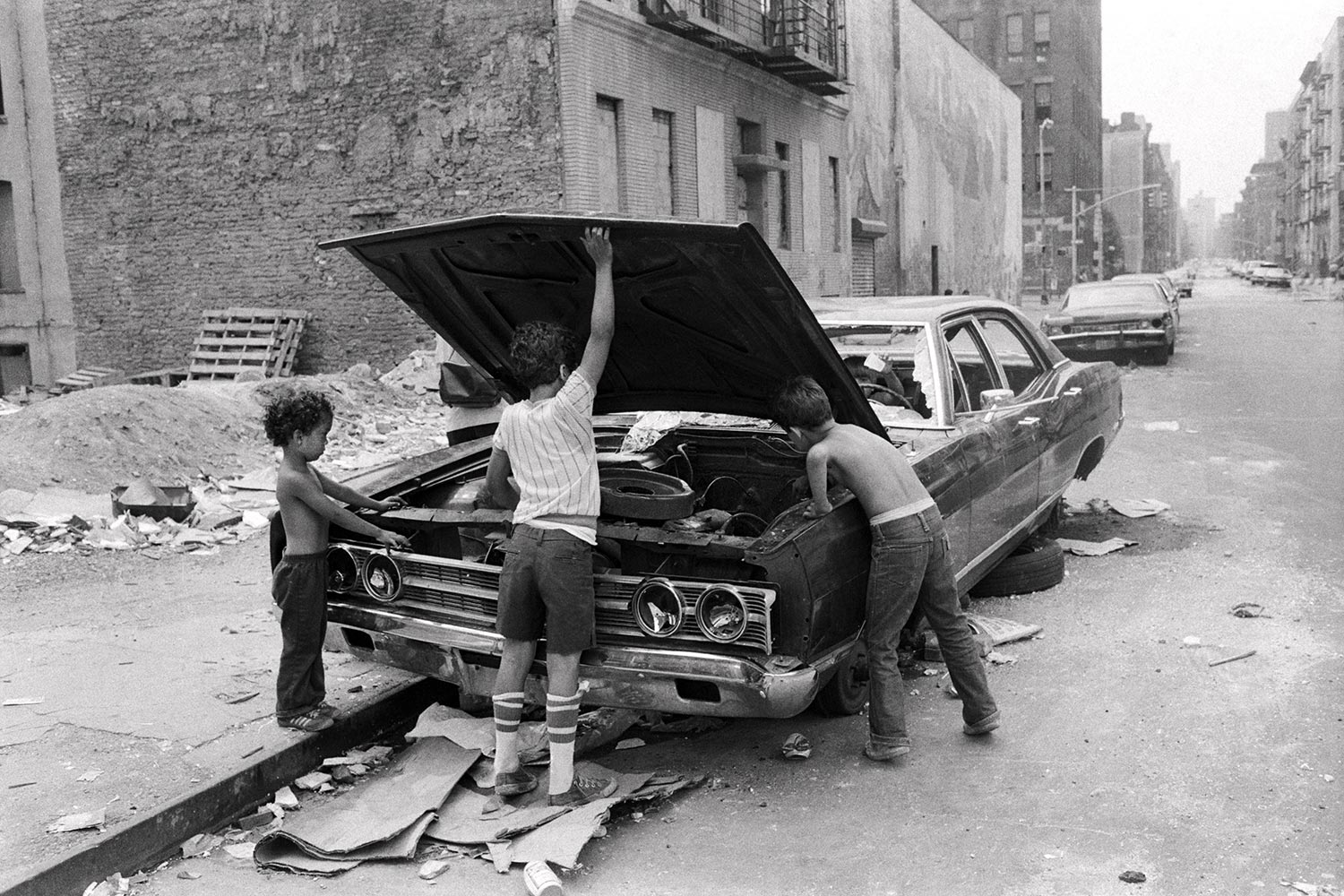 Lower East Side, New York City, 1978. Kids playing in street with car