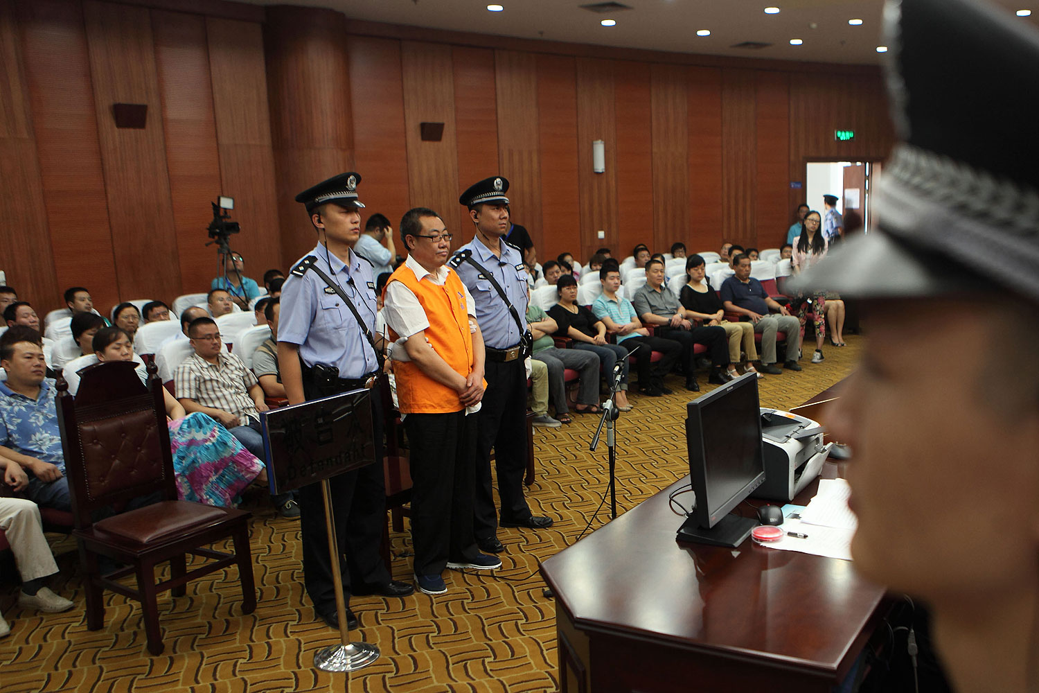 Yang Dacai (2nd L standing), a Chinese official branded 'Brother Watch' because of his expensive taste in timepieces, stands in the courtroom in the Intermediate people's court of Xian, northwest China's Shaanxi province on Sept. 5, 2013 (STR / AFP / Getty Images)