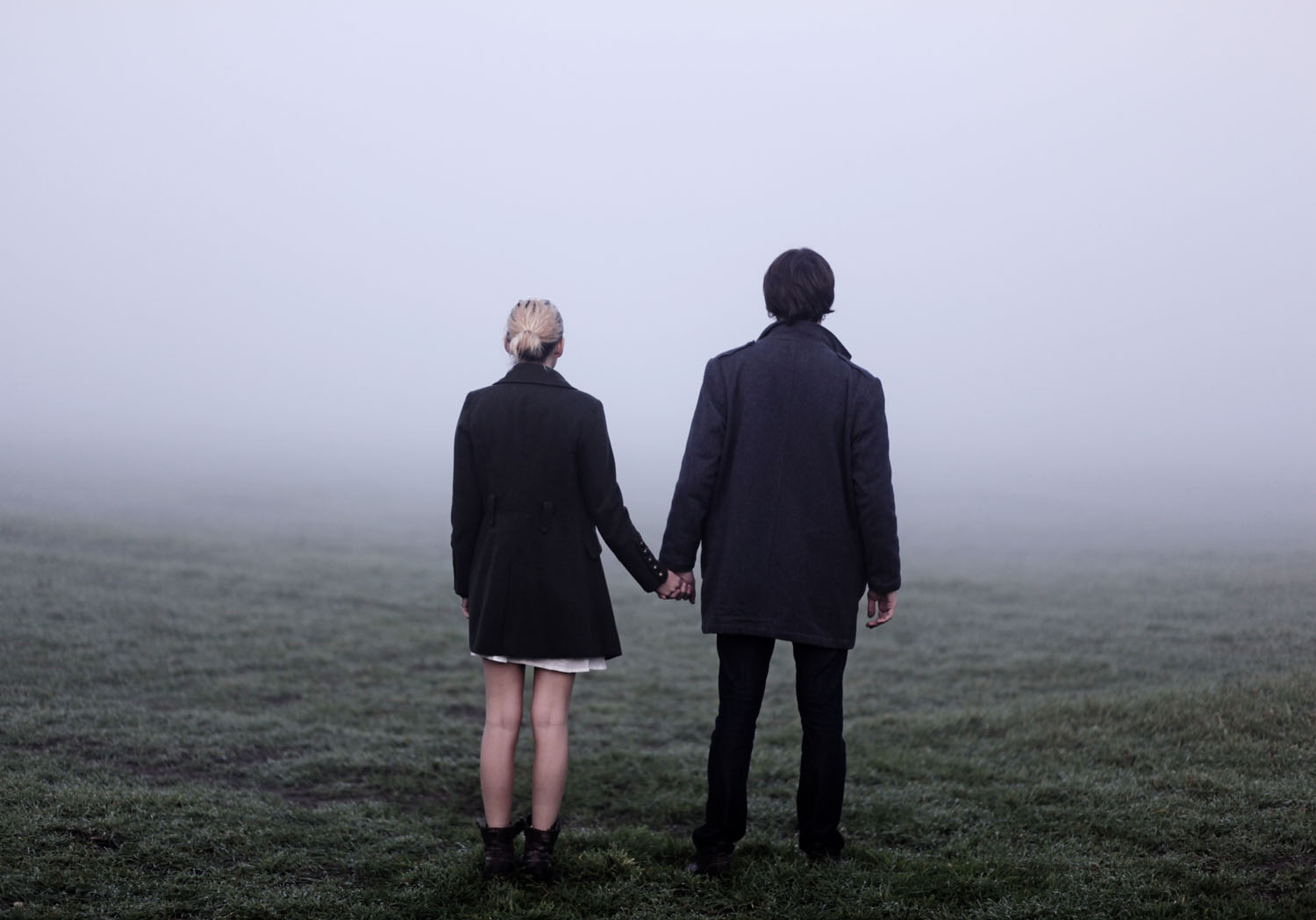 Couple holding hands outside in thick fog. (-Rekha Garton-&mdash;Getty Images/Flickr Select)