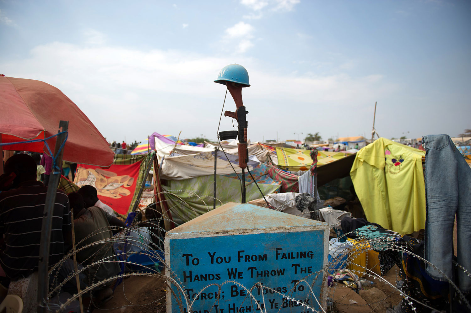 A monument for fallen peacekeepers stands amidst makeshift tents in a spontaneous camp for internally displaced persons at the United Nations Mission to South Sudan base in Juba, on Jan. 9, 2014.