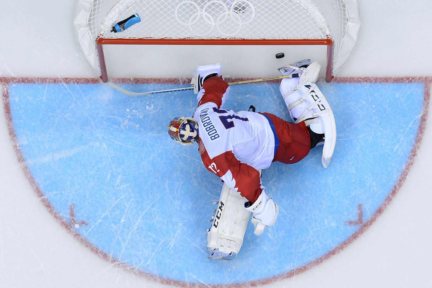 Russia's goalkeeper Sergei Bobrovski fails to stop a penalty during the Men's Ice Hockey Group A match USA vs Russia at the Bolshoy Ice Dome during the Sochi Winter Olympics on February 15, 2014 in Sochi.