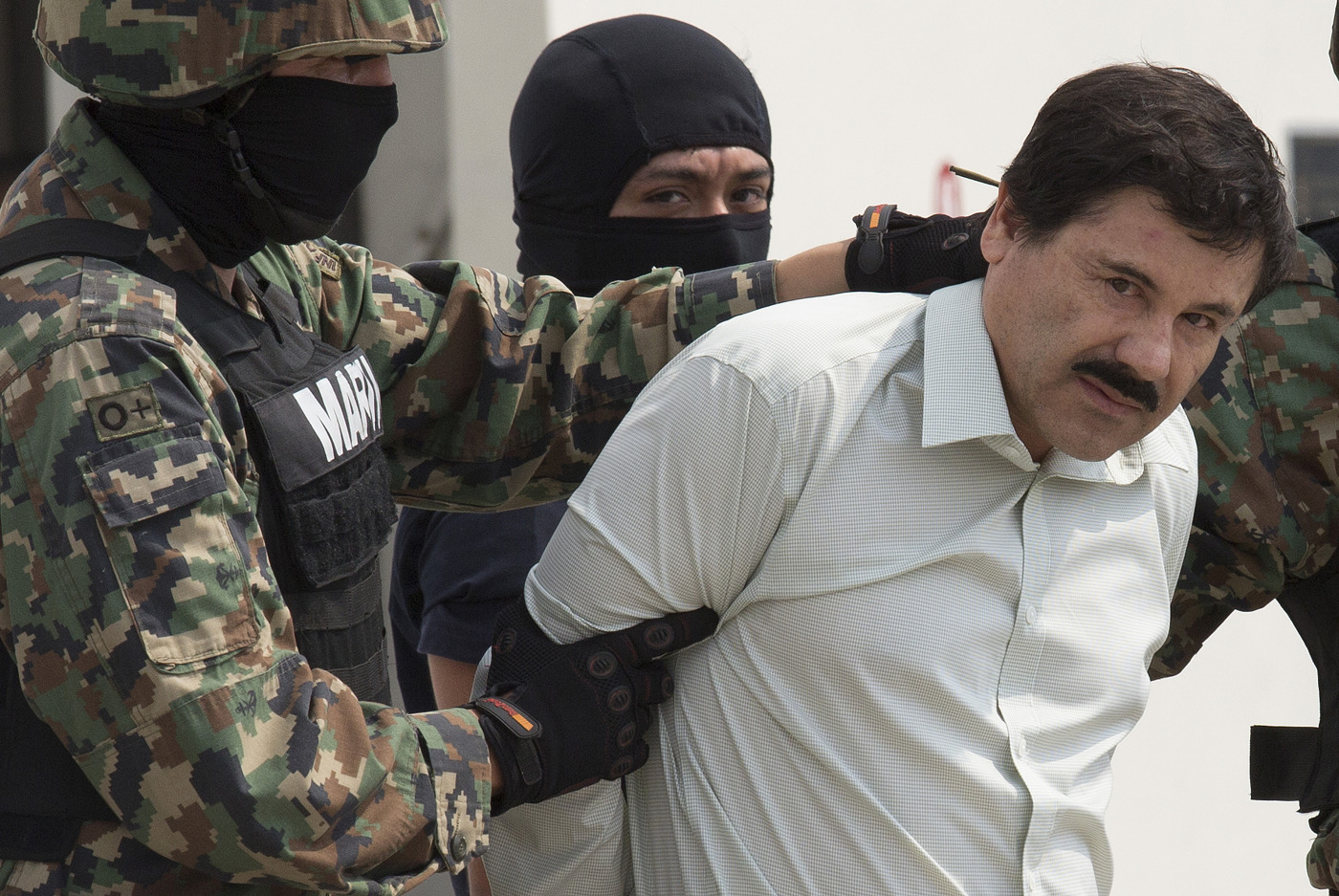 The drug trafficker Joaquín “El Chapo” Guzmán, guarded by members of Mexican navy, was arrested at a hotel in Mexico on Feb. 22, 2014 (Bloomberg&mdash;Getty Images)