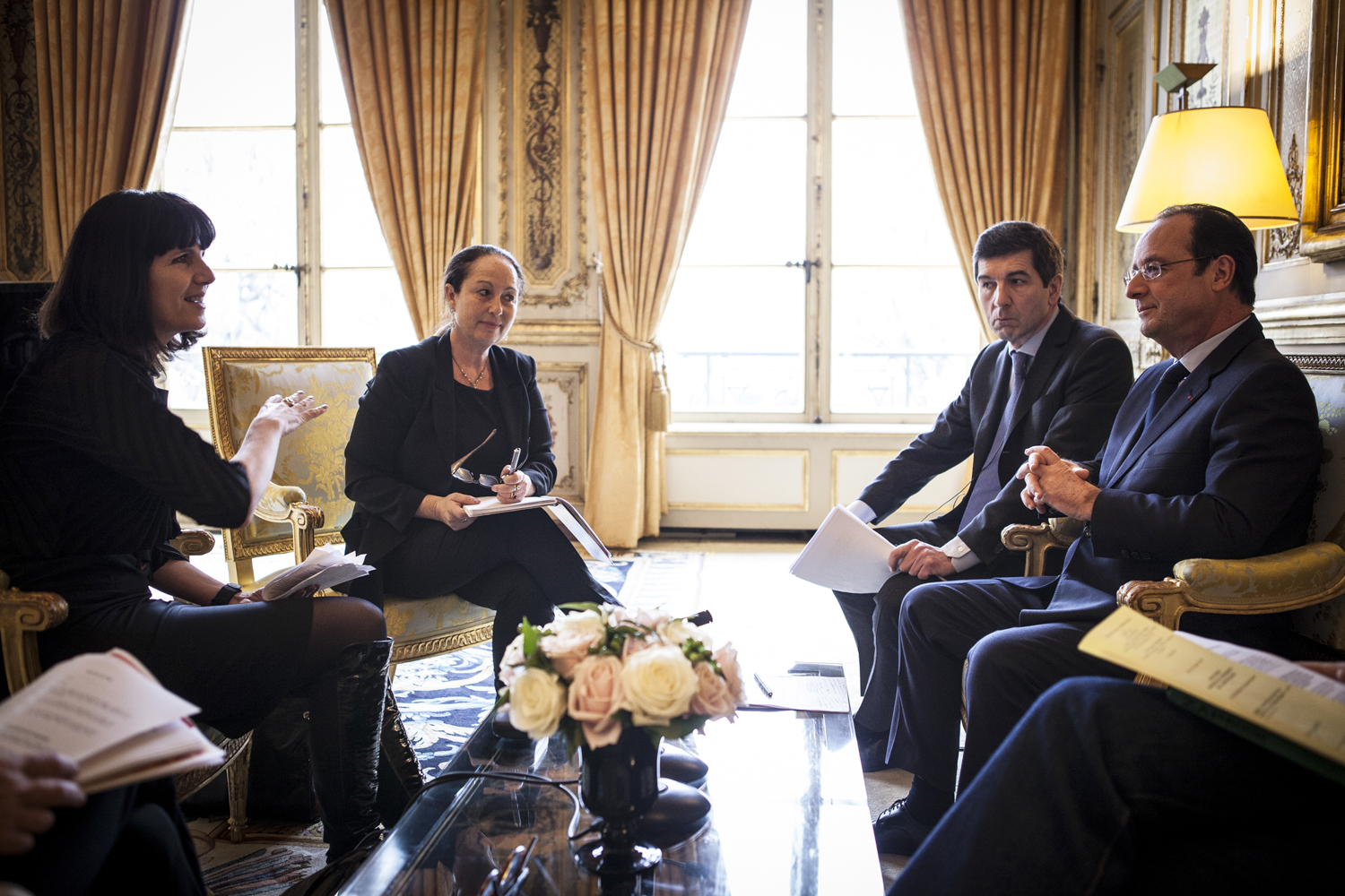 TIME's Catherine Mayer, left, and Vivienne Walt talk to François Hollande in the Élysée Palace, Paris. 