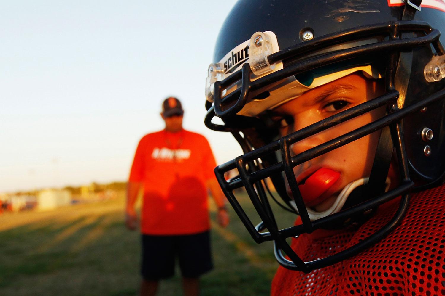 A youngster chews on his mouthguard during the filming of the television docu-series "Friday Night Tykes" in San Antonio, Texas.