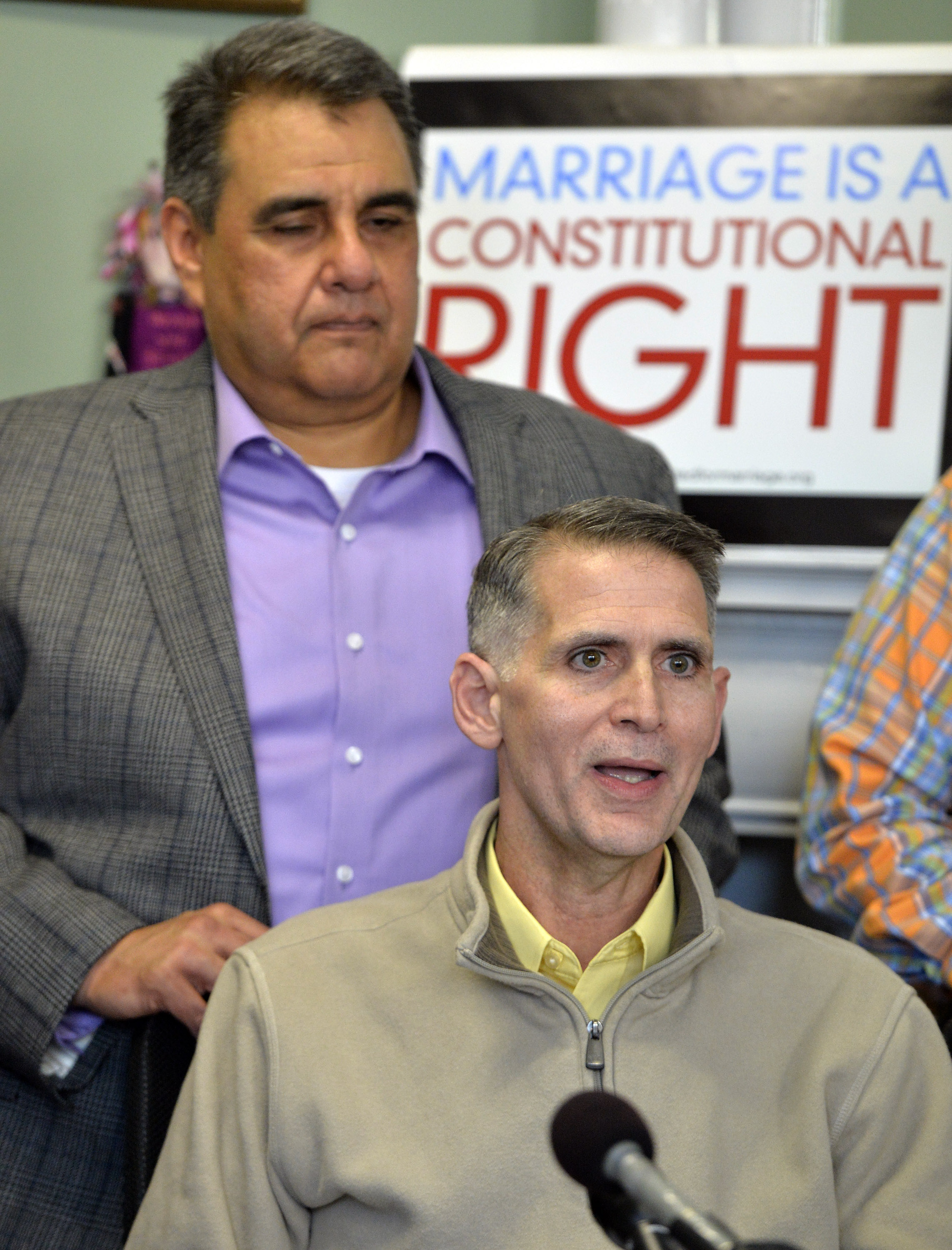 Greg Bourke, front, and his partner Michael Deleon speak to reporters following the announcement from U.S. District Judge John G. Heyburn striking down Kentucky's same-sex marriage ban Wednesday, Feb. 12, 2014, in Louisville, Ky.