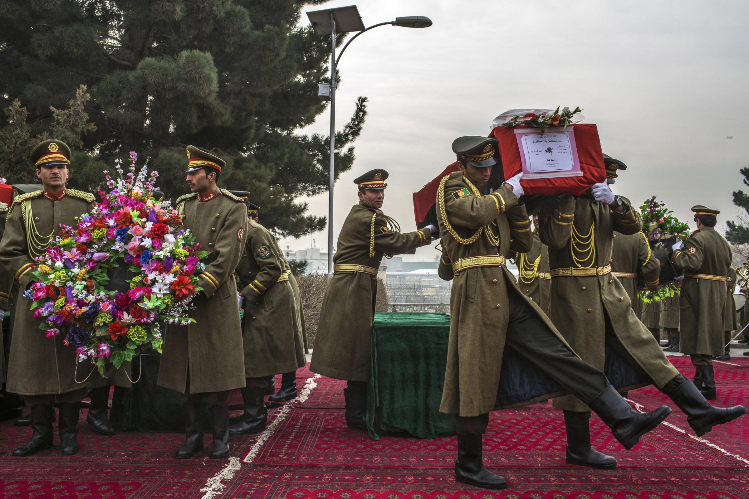 Afghan National Army members carry the coffins of fellow soldiers shot to death by Taliban insurgents, in Kabul, Afghanistan.