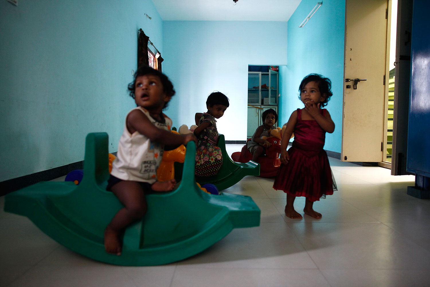 Baby girls play inside the Life Line Trust orphanage in Salem in the southern Indian state of Tamil Nadu June 20, 2013 (Mansi Thapliyal / Thomson Reuters Foundation)