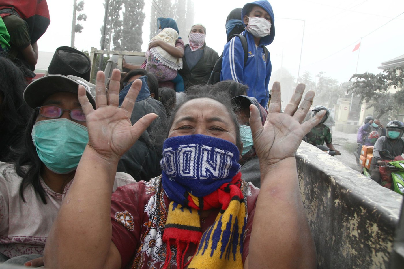A woman gestures during the evacuation in Malang, East Java province, on Feb. 14, 2014 moments after Mount Kelud's eruption.
