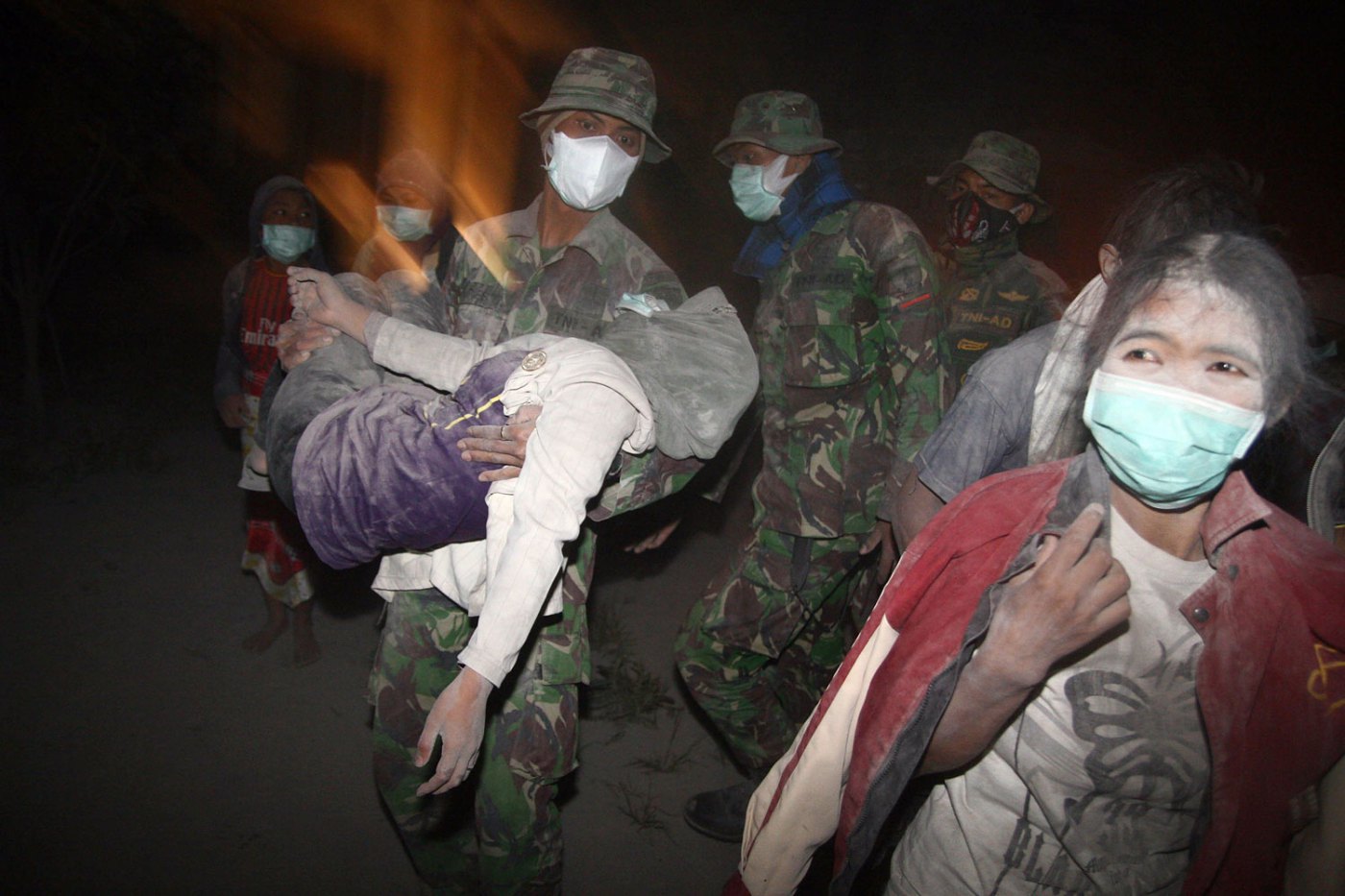 Indonesian soldiers evacuate ash covered residents in Malang, East Java province on Feb. 14, 2014 moments after Mount Kelud, considered one of the most dangerous volcanoes on densely populated Java, erupted.