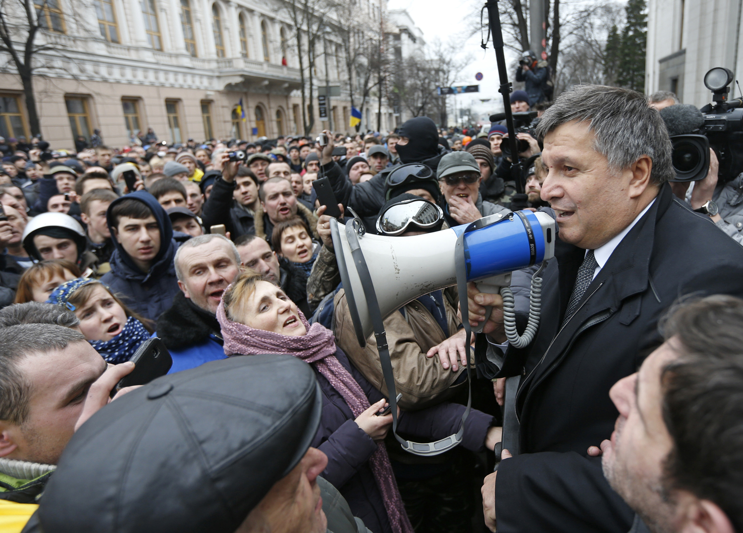 Newly elected Ukrainian interior minister Arsen Avakov (R) holds a loud-speaker as he addresses anti-government protesters outside the Ukrainian parliament building in Kiev February 22, 2014. (Vasily Fedosenko—Reuters)