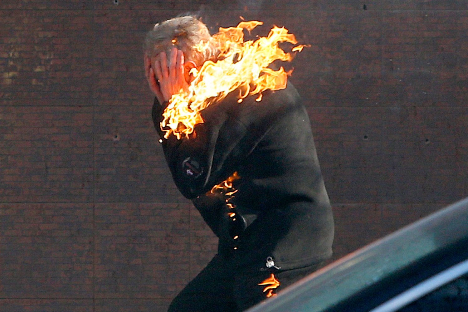 An anti-government protester is engulfed in flames while running from the scene during clashes with riot police outside Ukraine's parliament in Kiev, on Feb. 18, 2014.