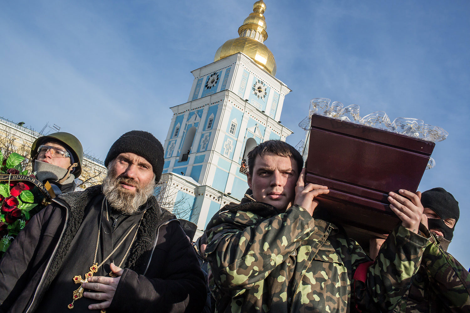 Men carry a casket containing the body of Mikhail Zhiznevsky, 25, an anti-government protester who was killed in clashes with police, outside Mikhailovsky Cathedral after a memorial service there in his honor on Jan. 26, 2014 in Kiev.