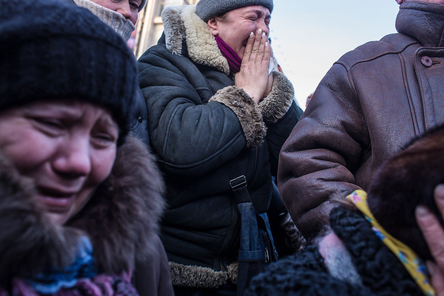 Women weep as a casket containing the body of Mikhail Zhiznevsky, 25, an anti-government protester who was killed in clashes with police, is carried past on Jan. 26, 2014 in Kiev.