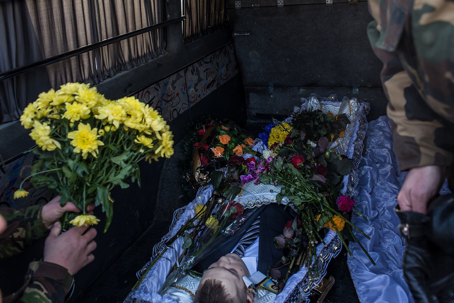 The body of Mikhail Zhiznevsky, 25, an anti-government protester who was killed in clashes with police, rests in the back of a hearse following a memorial service in his honor on Jan. 26, 2014 in Kiev.