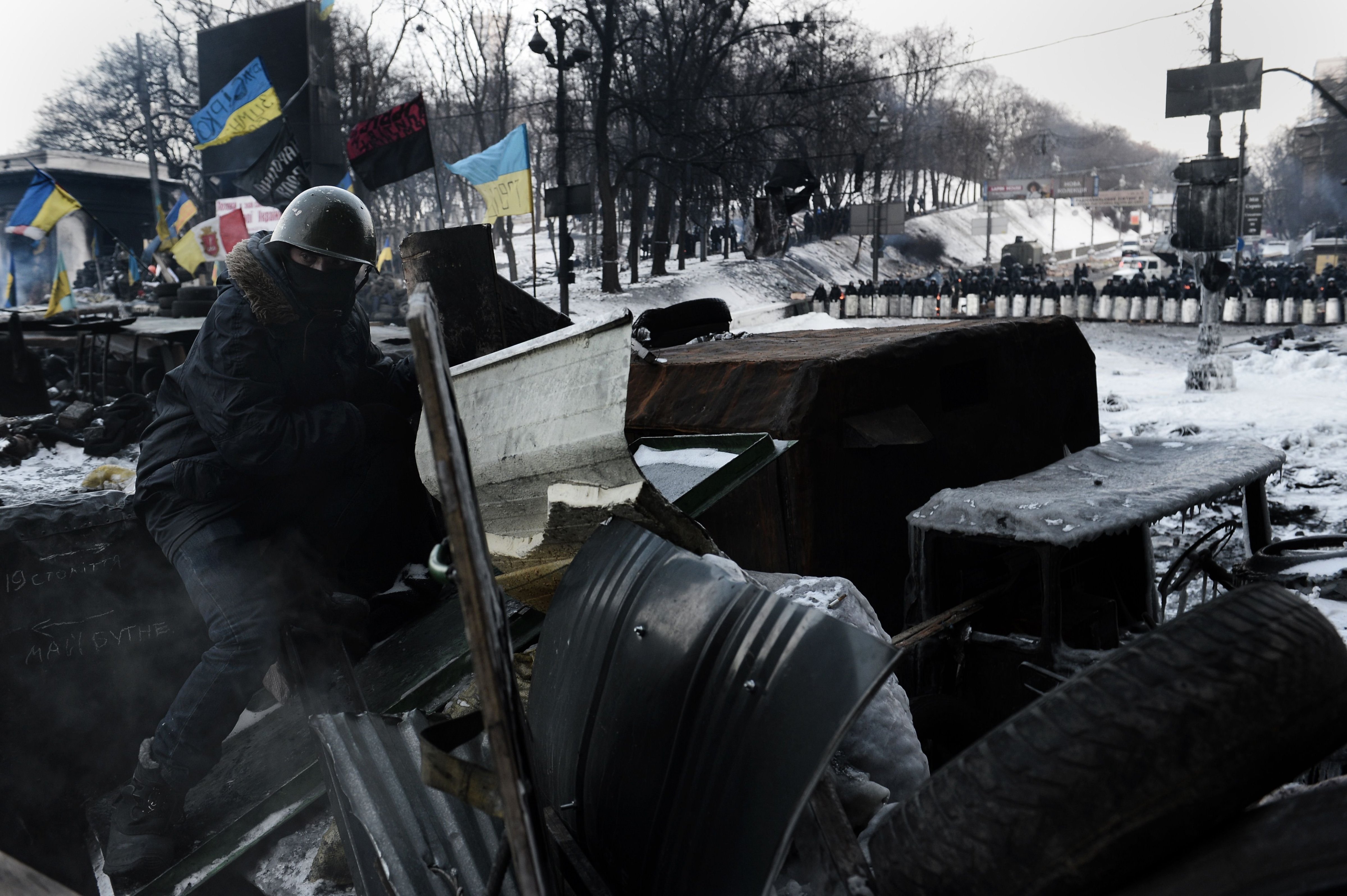 An anti-government protester sits at a road block in Kiev on Feb. 1, 2014. (Aris Messinis / AFP / Getty Images)