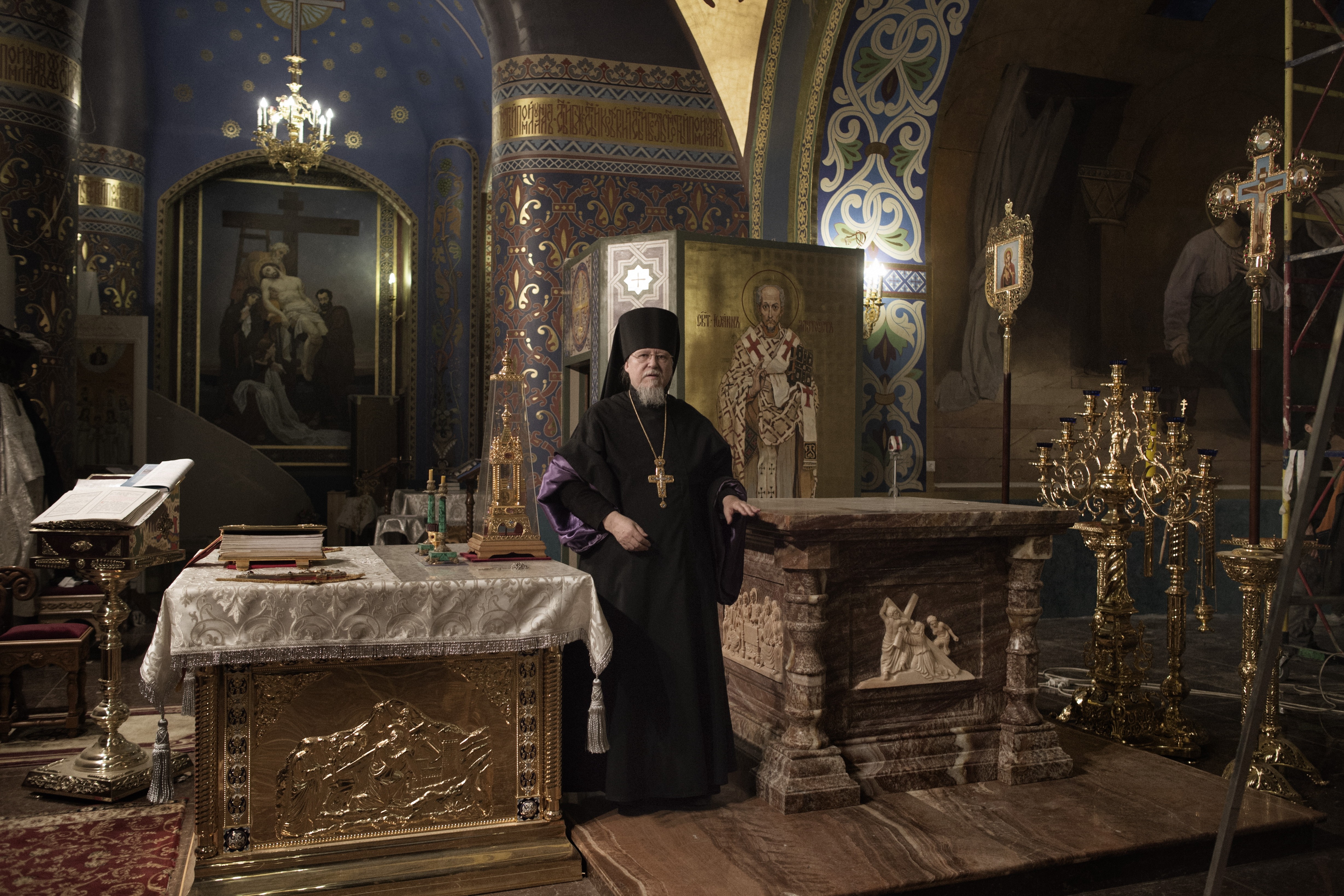 Sochi, Russia, Jan. 15,  2014: Father Flavian, the abbot of the Cathedral of the Holy Face of Christ the Savior, poses on its altar. The ornate cathedral, which stands inside the Olympic village in Sochi, was built in  one year.