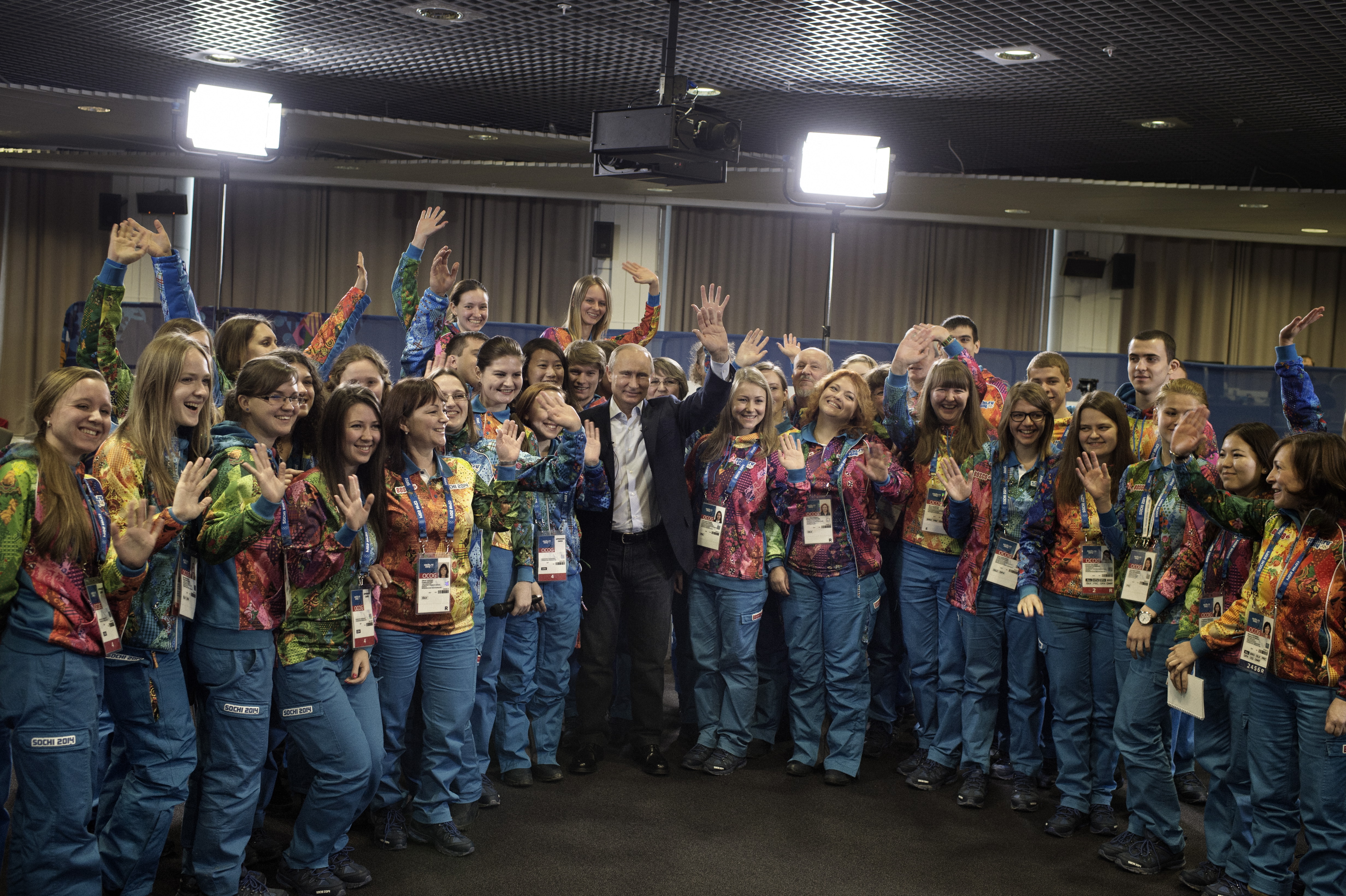 Sochi, Russia, Jan. 17, 2014: Russian President Vladimir Putin poses with a group of Olympic volunteers who will help coordinate the Winter Games in Sochi.