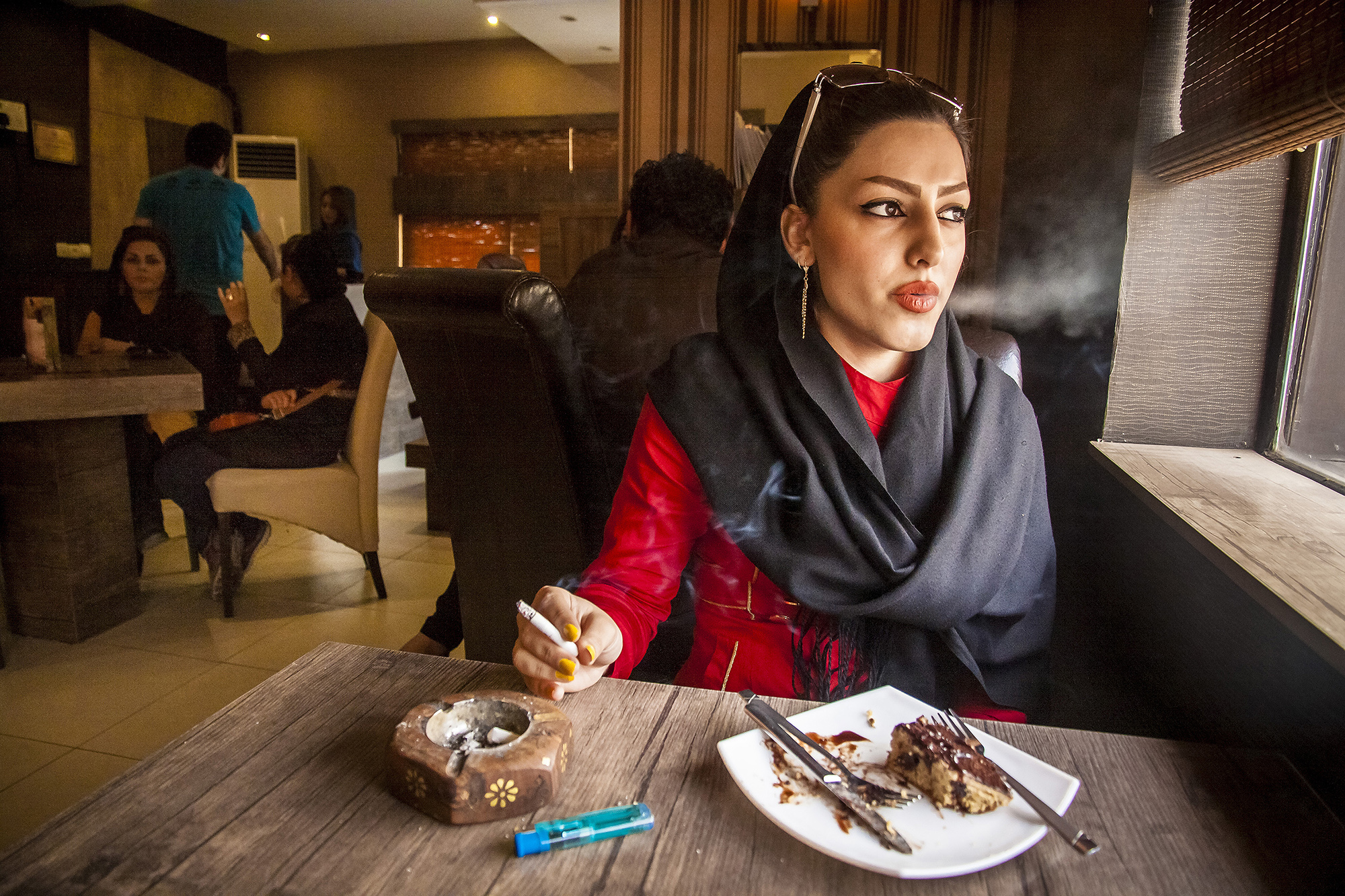 Mehran Hamrahi won the student Alexia competition for his story on "Iranian People, Ordinary or Criminals." Sheida, 18, smokes a cigarette in a café in Ahvaz, Southern Iran, July 1, 2013. She said, "I feel safe in the café." Smoking the cigarette is not restricted legally in Iran, however the girls are afraid of smoking in public places. The radical Muslims and traditional people consider this as a abominable act for girls.