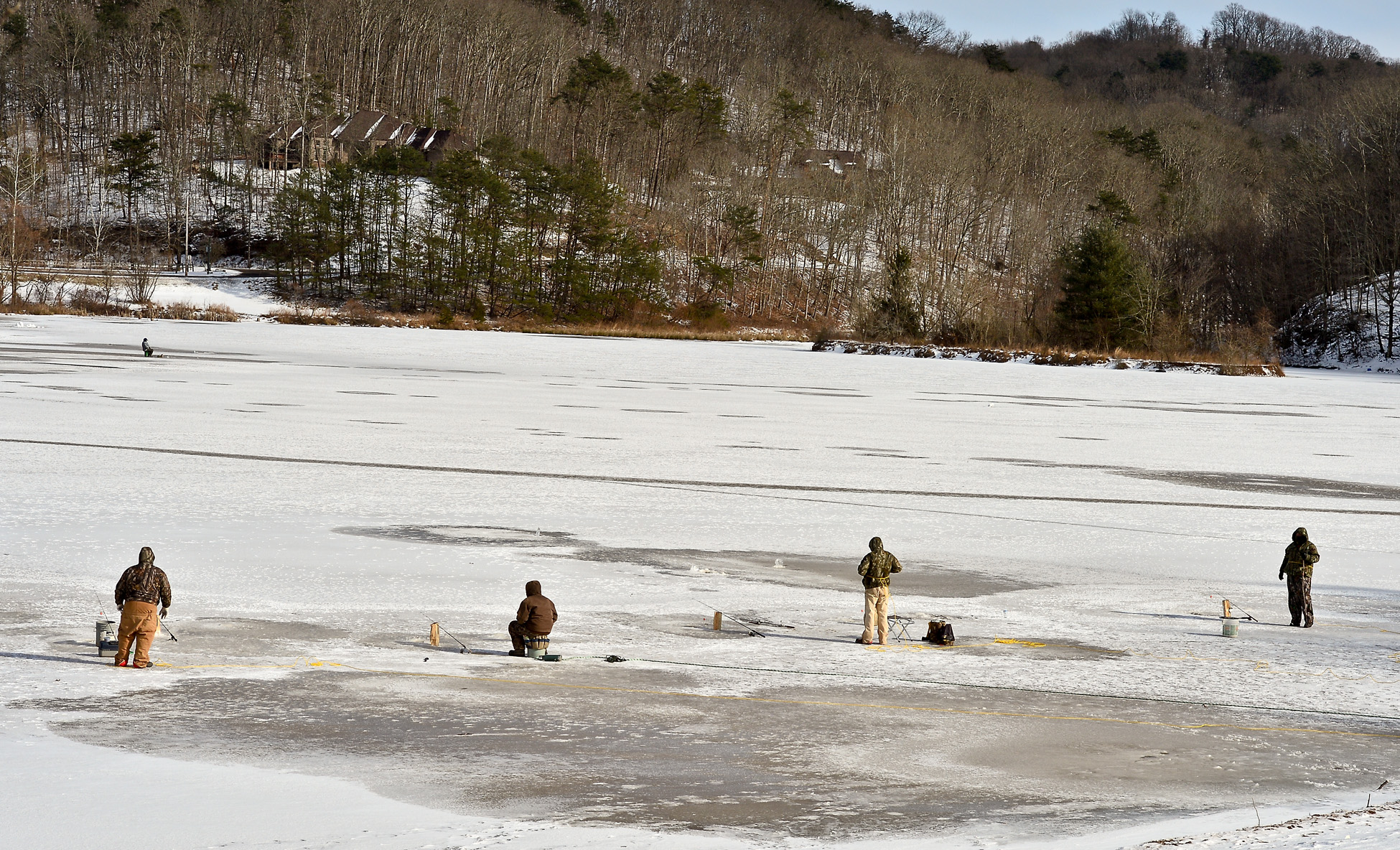 A group of ice fishers gather on the frozen surface of Ridenour Lake in Nitro, W.Va., Jan. 27, 2014.   